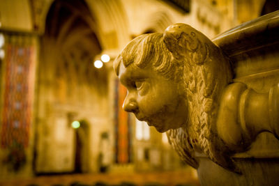 Carved marble head on side of cathedral font