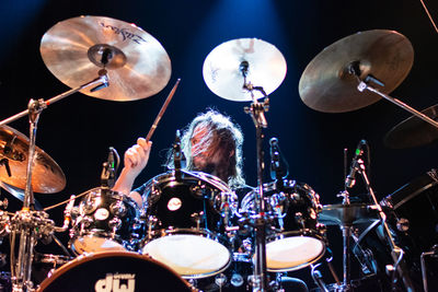 Low angle view of man playing at music concert