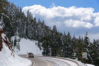 Cars on road against sky during winter