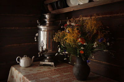 Flower vase on table at home