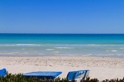 Scenic view of beach against blue sky