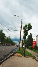 Street by road against sky