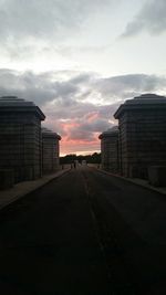 Empty road against cloudy sky