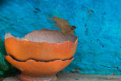 Close-up of pumpkin against blue wall