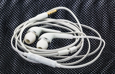 Close-up of in-ear headphones on fabric