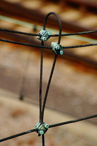 Close-up of chain hanging on fence