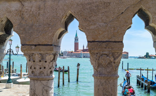 People at sea seen through arch