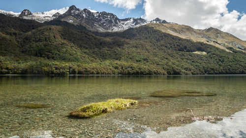 Scenic view of lake and mountains against sky