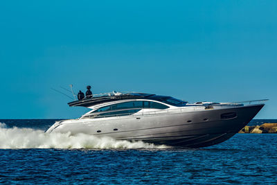 Ship in sea against blue sky