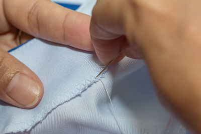 Midsection of tailor sewing textile