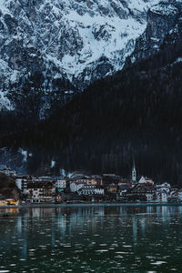 Scenic view of lake by snowcapped mountains during winter