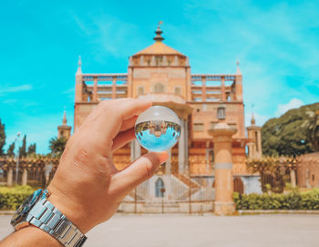 Man holding umbrella in city