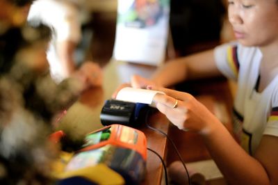 Midsection of man holding mobile phone