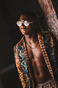 Low angle view of young man wearing sunglasses