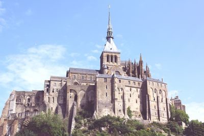 Low angle view of mont saint-michel against the sky