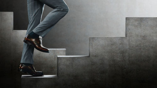 Low section of man standing on wall