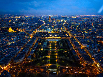 High angle view of city lit up at night