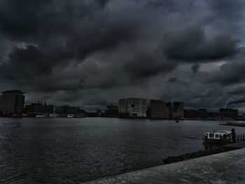 Buildings against cloudy sky