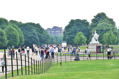 Group of people in park against clear sky