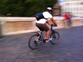 Blurred motion of man skateboarding on road