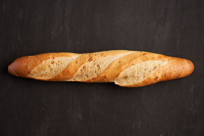 High angle view of bread on table against black background