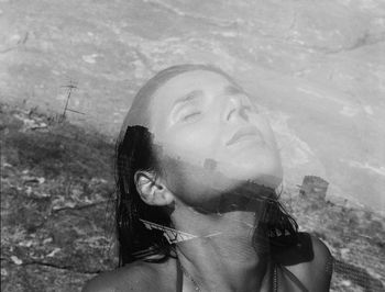 Portrait of young woman standing against sky