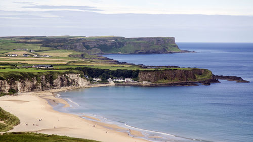 Scenic view of mountain and sea against sky at white park bay