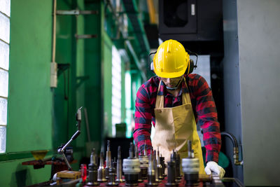 Side view of man working in factory