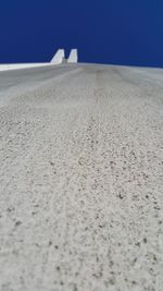 Close-up of sand dunes against clear blue sky