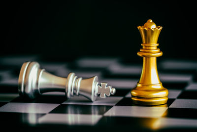 Close-up of king and queen on chess board