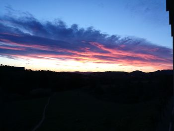 Scenic view of silhouette landscape against dramatic sky