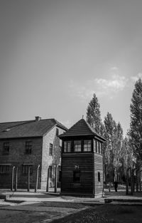 Houses and trees against sky in city