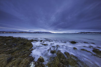 Scenic view of sea against blue cloudy sky