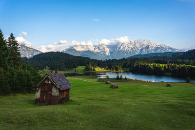 Scenic view of field and mountains against sky