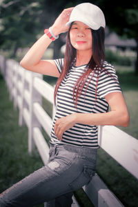 Portrait of smiling young woman wearing hat