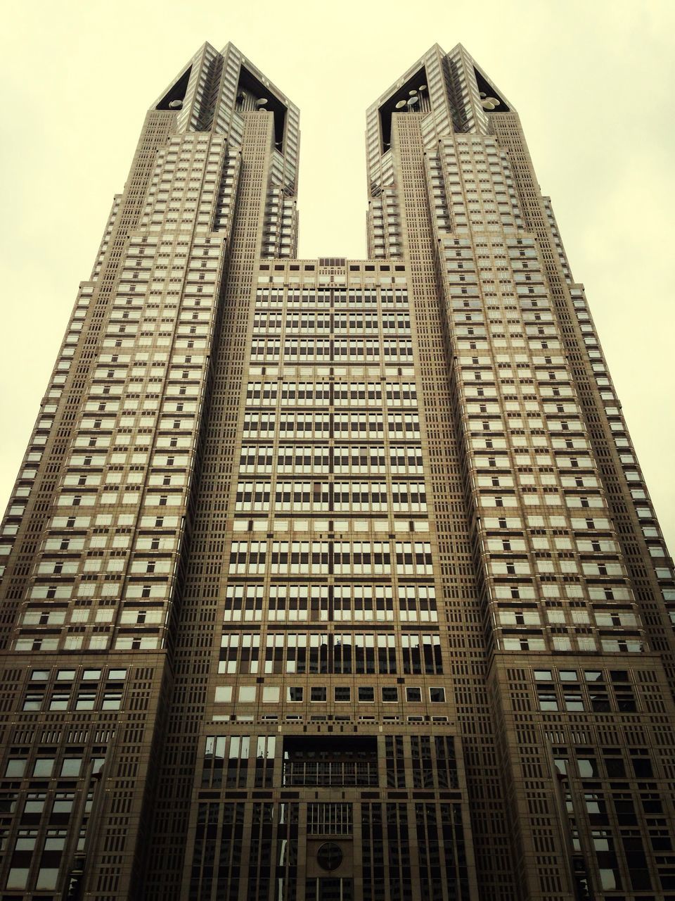 architecture, building exterior, built structure, low angle view, skyscraper, city, tall - high, modern, office building, tower, building, tall, sky, clear sky, financial district, city life, glass - material, outdoors, day, no people