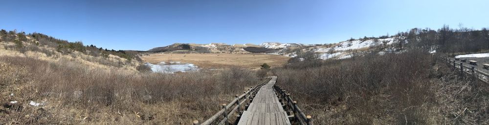 Panoramic view of railroad tracks against clear sky