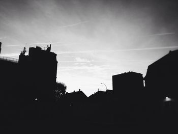 Low angle view of silhouette buildings against sky