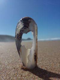 Close-up of sand on beach against sky