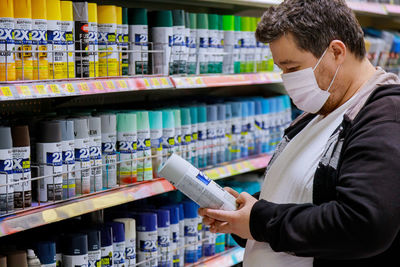 Side view of man standing in store