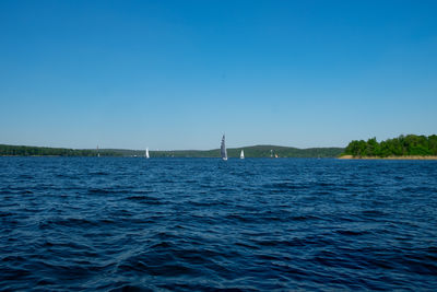 Scenic view of sea against clear blue sky