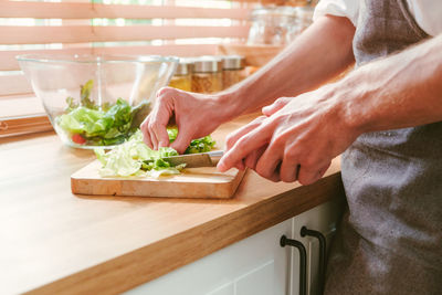 Midsection of man preparing food on table