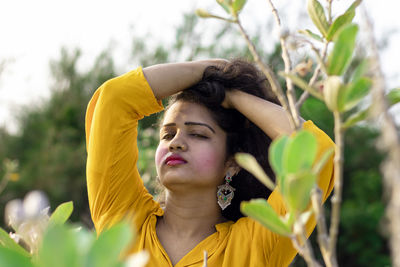 Portrait of young woman looking away outdoors