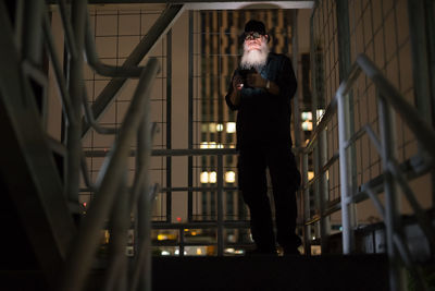 Young man standing on railing