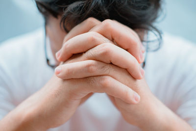 Close-up of man with hands clasped