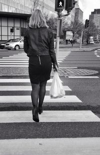 Woman standing on city street