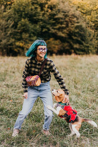 Full length of young woman standing on field