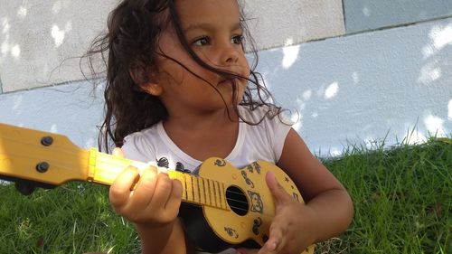 Portrait of a girl playing guitar