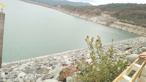 High angle view of lake and mountains against sky