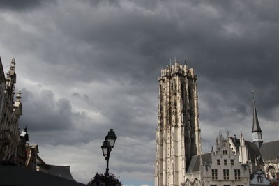 Low angle view of buildings against cloudy sky